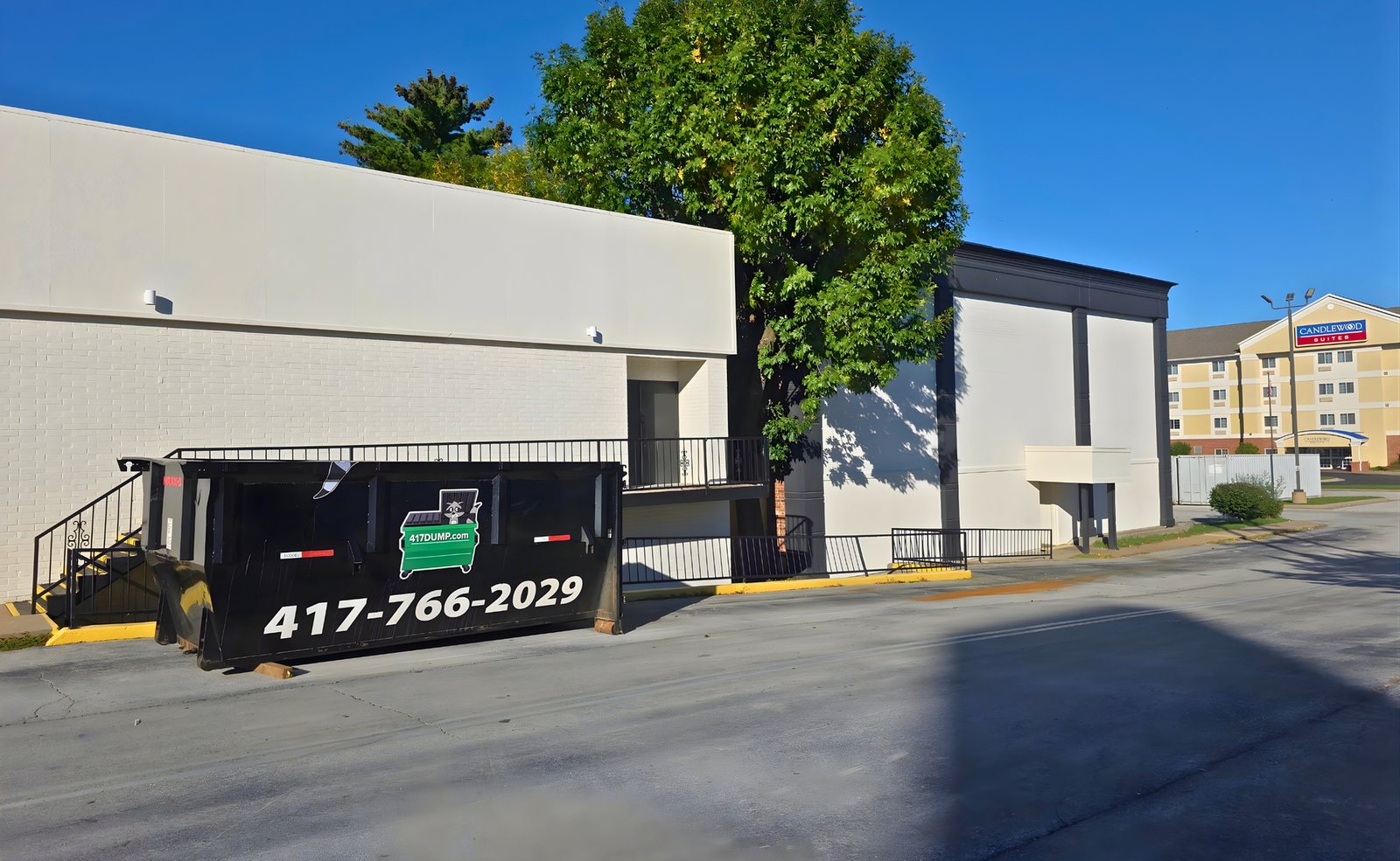 Black 417 Dumpster Rental roll-off dumpster at a commercial building
