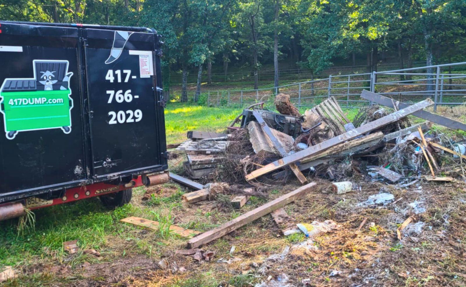 Roll-off dumpster filled with lumber and cleanout debris